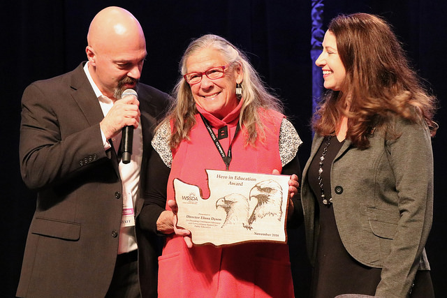 Tim Garchow and Tricia Lubach handing out Hero in Education award to Elissa Dyson.