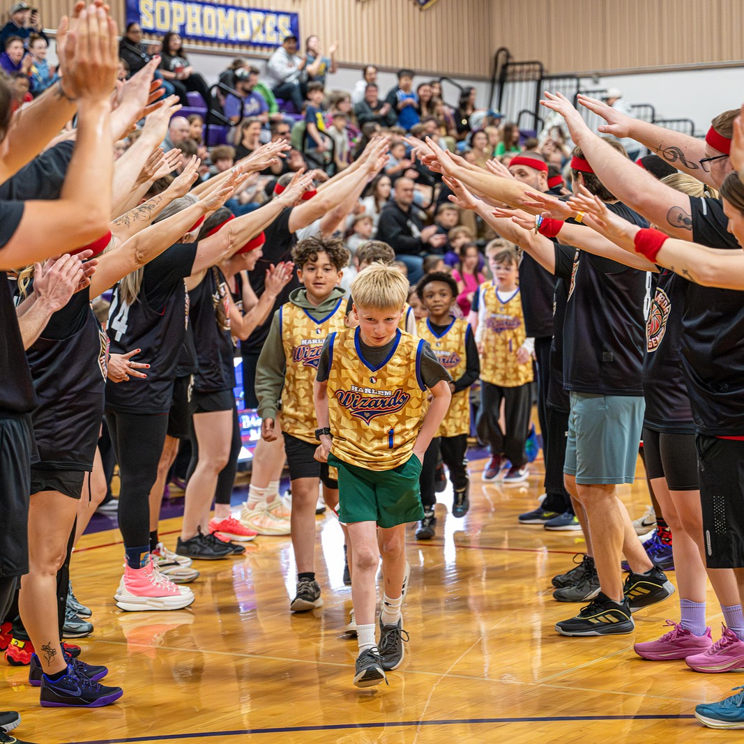 Students playing at a basketball game.